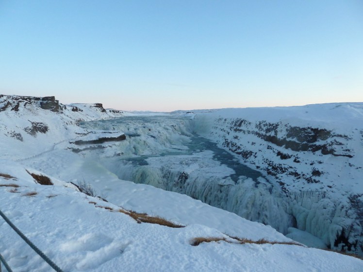 Gullfoss, a large waterfall. In this picture it's December and it's mostly frozen over.