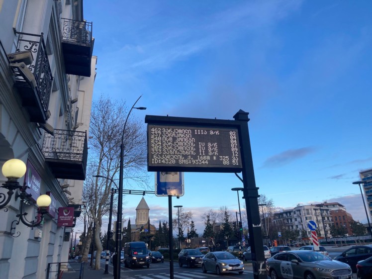 A photo of the LCD display board at the bus stop where I took the bus to Tbilisi Airport.