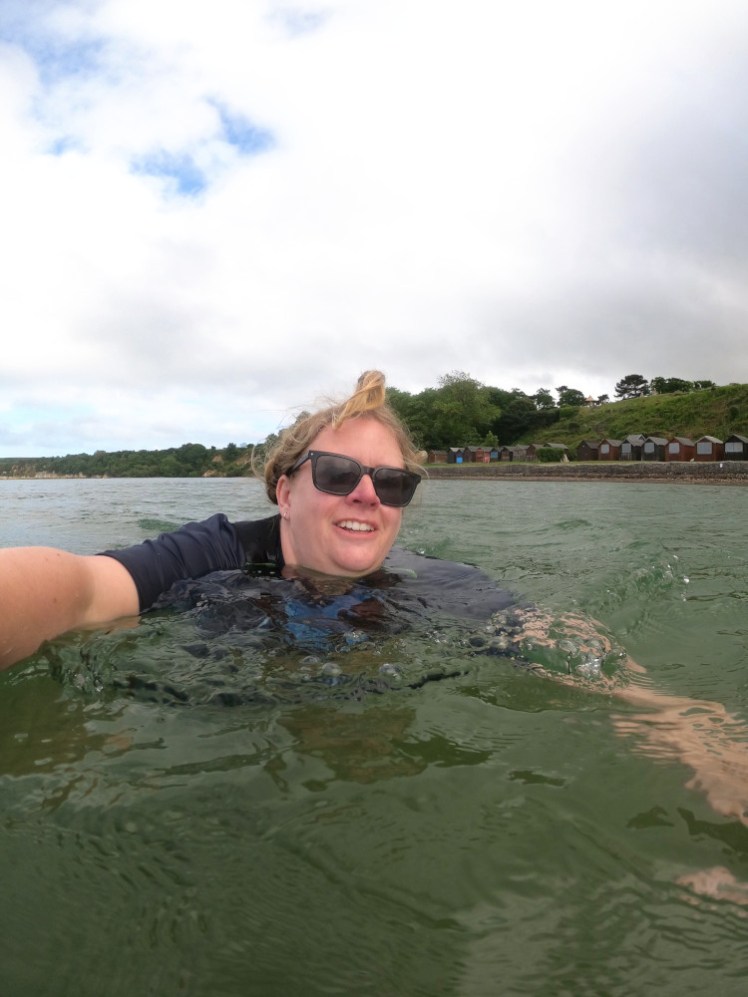 Me in a rash vest and long john wetsuit swimming in the sea. It's shallower than it looks for how far out I seem to be.