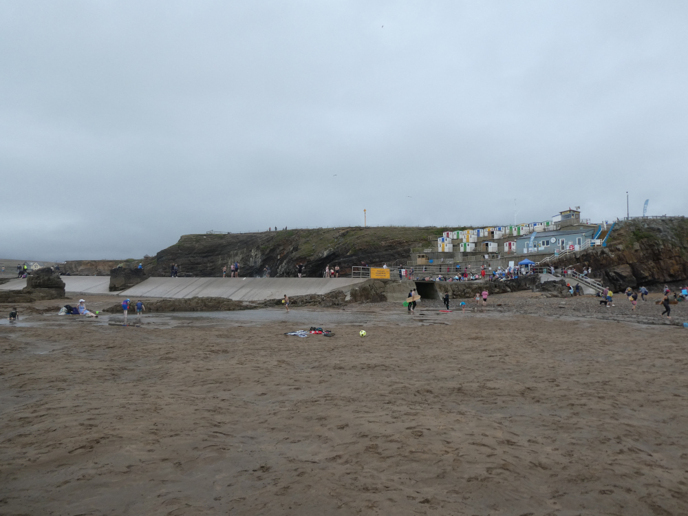 Bude Sea Pool from the beach at low tide - a big concrete wall with the terraces over to the right.