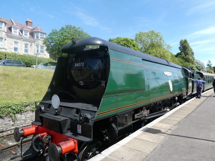 Battle of Britain class steam locomotive in the sun at Swanage station, this time attached to the train and pointing in the right direction.