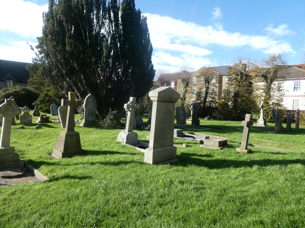 The graveyard at the Trinity Centre, a collection of well-maintained stone crosses and pillars in some equally well-maintained grass.