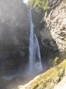 Reichenbach Falls, a long thin waterfall falling into a corner of the mountain.