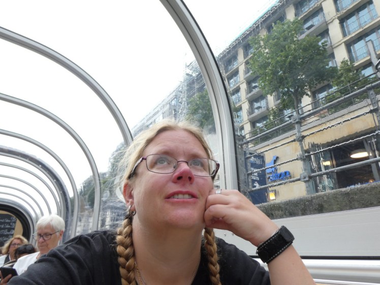 A selfie under the closed canopy of the boat. It's pouring with rain and I'm looking up at the rain on the roof above me.