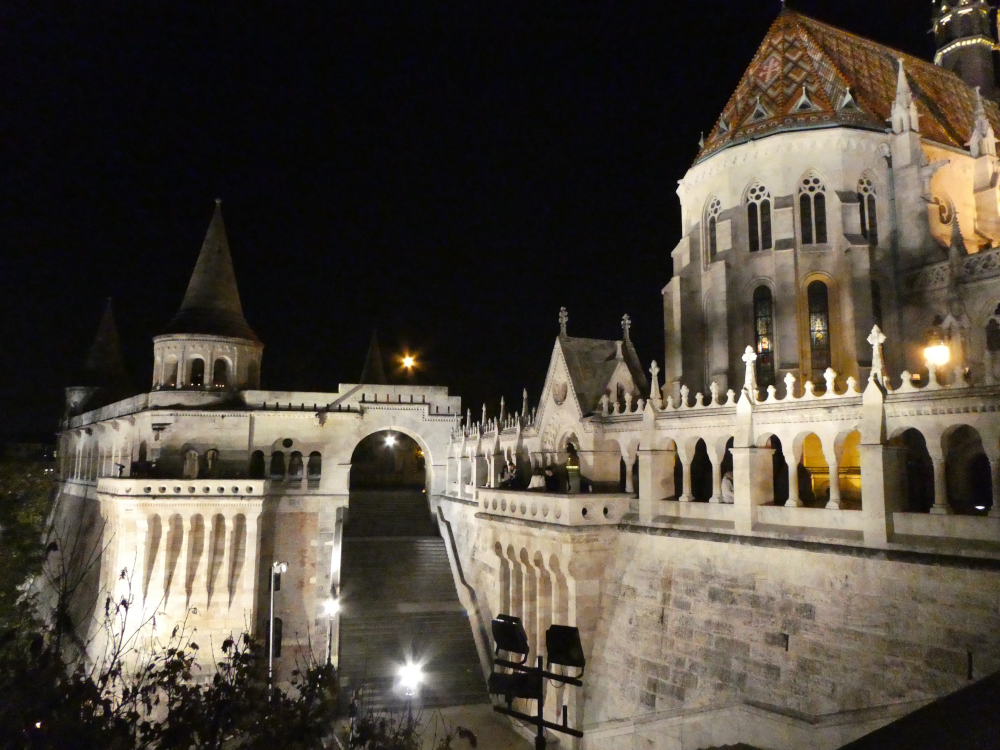 The Fishermans Bastion by night, as seen from opposite the viewpoints in the previous picture, now on the other side of the great staircase. Everything is lit up in white lights, whereas most of Budapest is lit in golden-yellow.