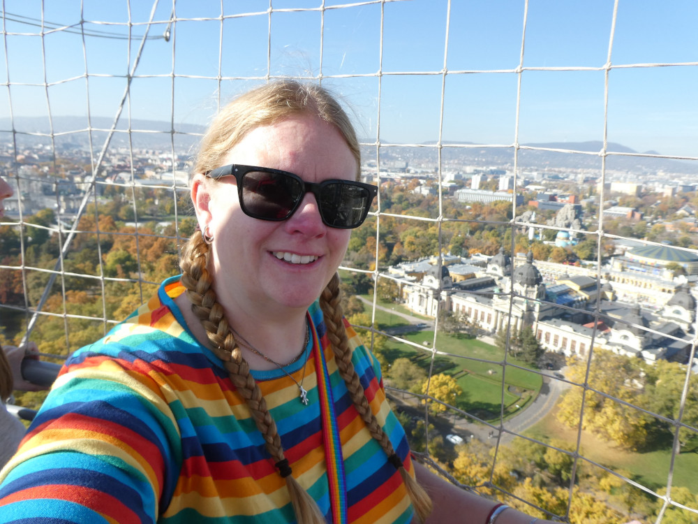 A selfie in a rainbow-striped top from a balloon overlooking the park in Budapest.
