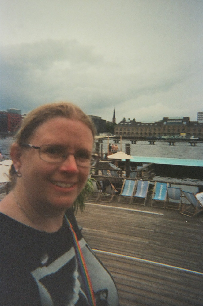 A selfie with the usual film graininess taken with Berlin's Badeschiff in the background.