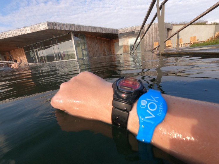 My black & pink Baby G watch in the pool at Vök Baths. I'm actually taking a photo of the nice blue branded Vök Baths electronic wristband but the watch comes with it.