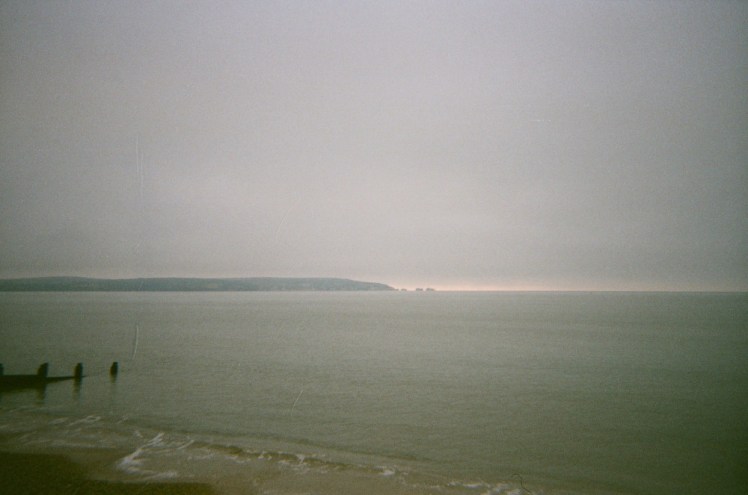 The Isle of Wight visible across the Solent. It's a grey cloudy day, which isn't helping the film haze on the photo.
