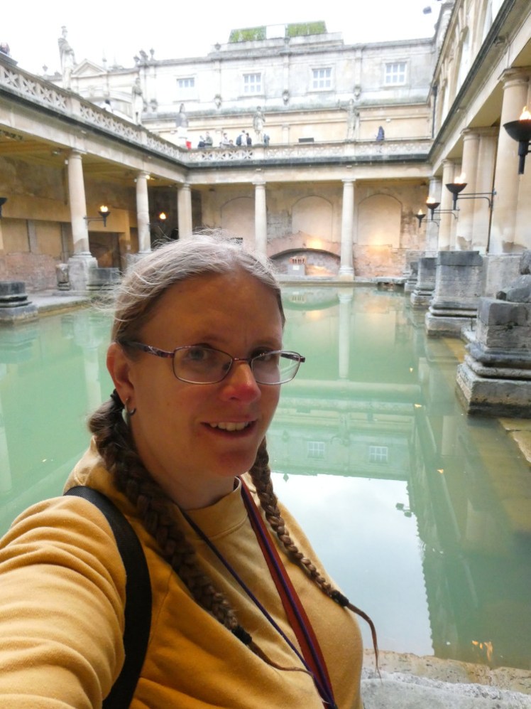 A selfie with the main bathing pool. I'm wearing a yellow jumper and my hair is wet from spending the morning in the Thermae Spa.