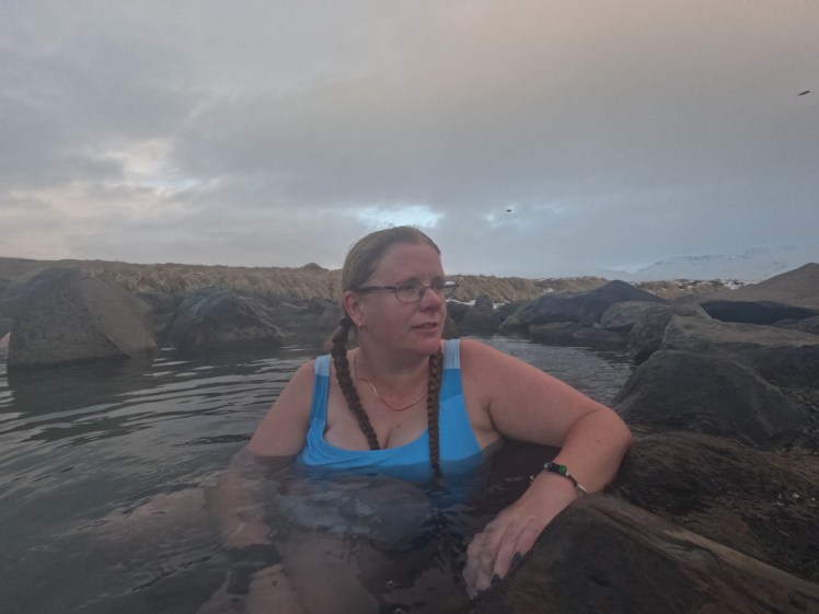 In a natural geothermal pool, wearing slender gold hoop earrings, one of my gold chains around my neck, an El Camino bracelet and my silver chain bracelet - the bangle is missing and I did lose it on this trip but I thought it was a few days later.