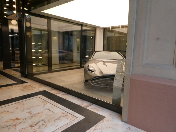An Aston Martin Vanquish parked in the right-hand window of the Aston Martin shop. There was a Vantage in the other side, along with colour samples, besuited staff and clientele drinking wine but it felt rude to take photos of them.