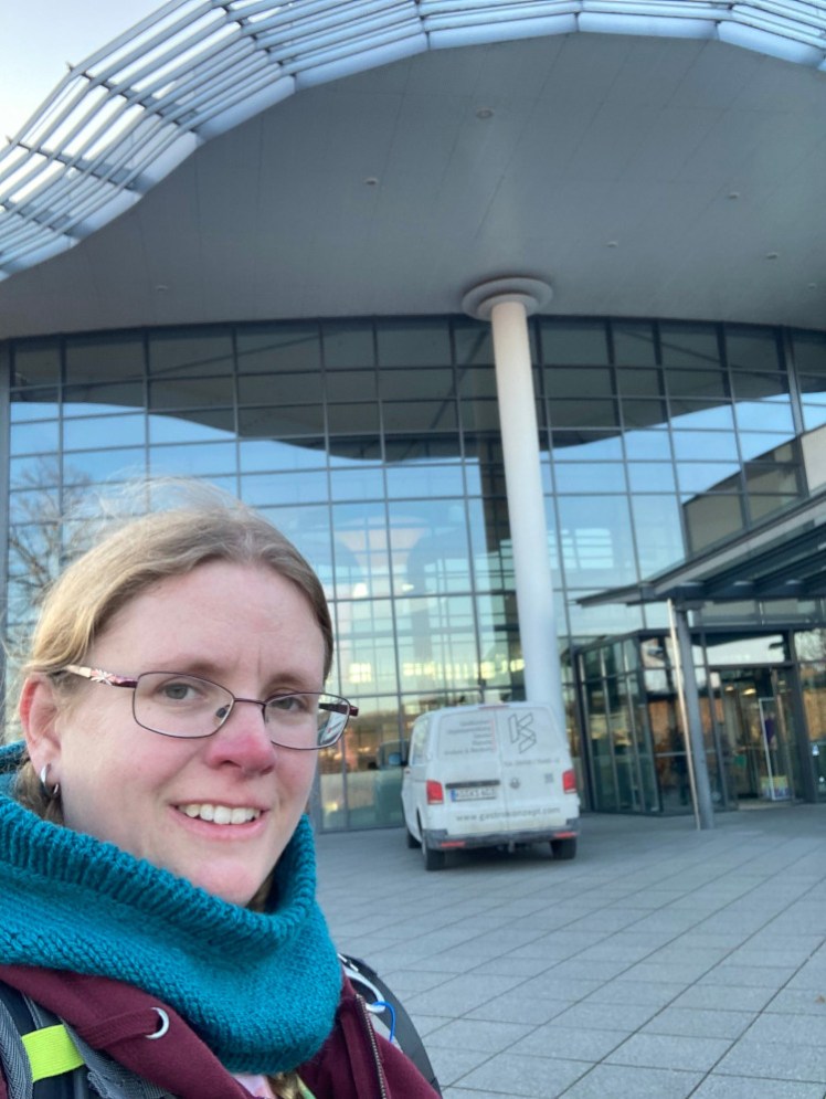 A selfie outside KissSalis, wearing the same blue knitted hood and reddish hoodie I've been wearing in every picture in this series.