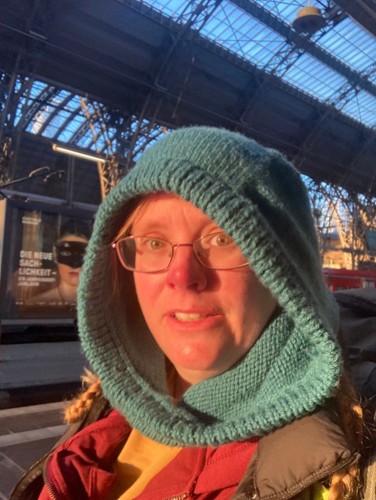 Another selfie at Frankfurt, this one taken while hurrying. I'm still wearing the hood, which just enhances the redness of my face. It's not really from hurrying, it's more because I'm hurrying directly into the sunset.