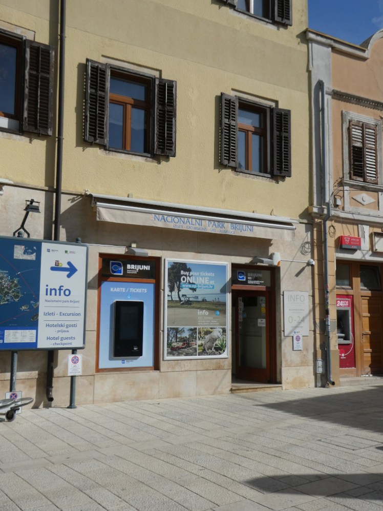 The Brijuni sales office in Fažana, a yellow building just off the end of the stone jetty.