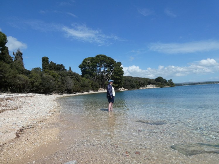 A timer selfie of me with my trousers rolled up and standing ankle-deep in the clear blue water, which is much more of a pale turquoise from this angle.