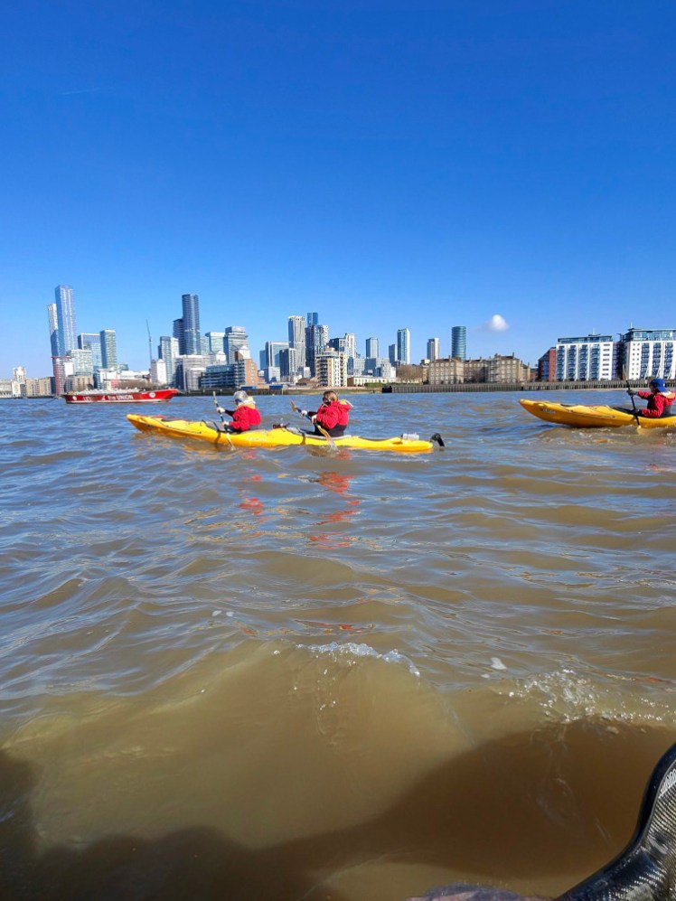 Our kayak plus the other one half in the photo with the glass forest that is the Isle of Dogs behind us.