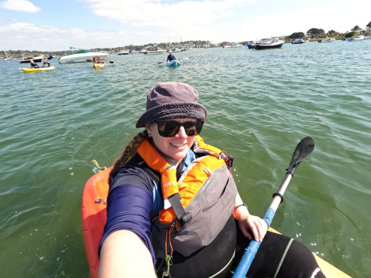 Me in a sit-on-top kayak at the county adult leader watersports day. Behind me, you can just make out three more kayaks, one double and two single, containing the other three participants, our instructor and a dog.