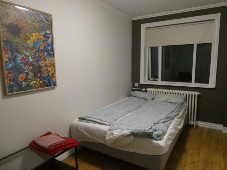 My double room in the Downtown Guesthouse Reykjavik. It's a double bed with two sets of single bedding and a large window behind it that is currently pitch black because the picture was taken after 4pm in December. You can tell it's a very basic room but it's perfectly functional.