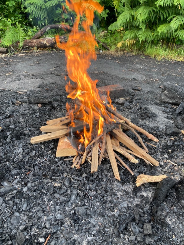 The first campfire, a lovely little column of orange fire rising from a "wigwam" of sticks - I favour Jenga for woodburners but wigwams for outdoor fires.