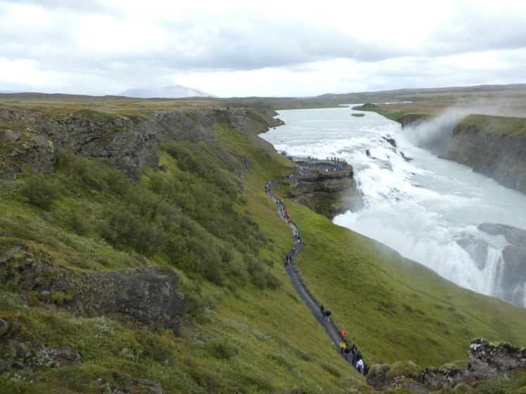 A view across the massive Gullfoss waterfall as seen from the viewpoint at the top, main car park, level. There's a path down below leading to a rock sticking out into the middle of the waterfall and you need to walk down metal steps to get to that path, unless you park at the lower car park.