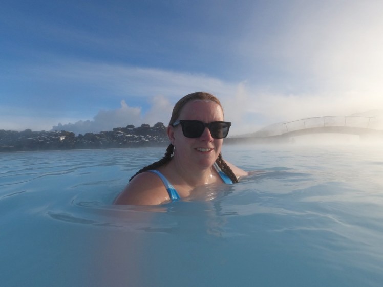 A selfie in the Blue Lagoon, the water much the same colour as the blue sky above me and a heavy mist sitting over the water.