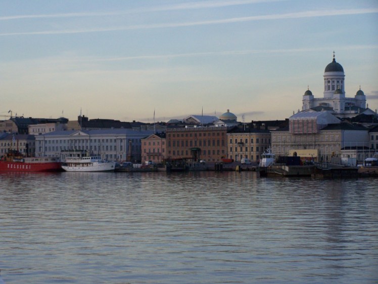 Helsinki seafront, as seen from a boat entering the harbour as the sun begins to set in the winter afternoon.