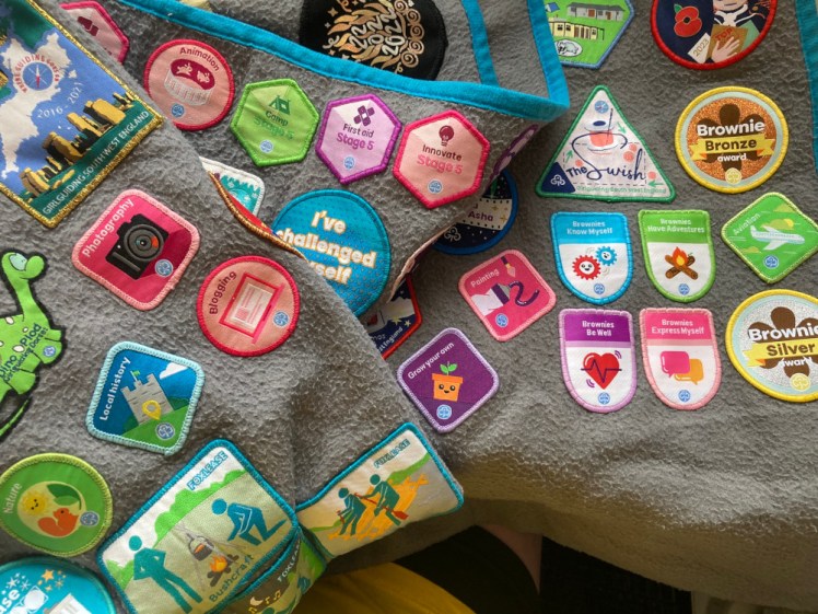My camp blanket, folded to show as many Girlguiding programme badges as possible.