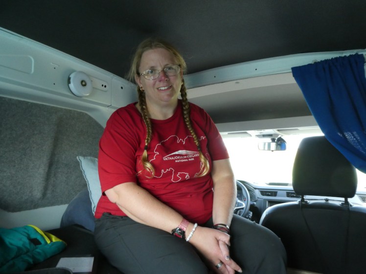 Me in the van, wearing a red t-shirt. My head is nearly touching the lightly-padded ceiling.