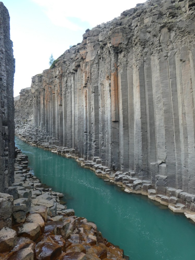 The narrowest part of the canyon, hammed in by walls of basalt columns and the green-blue river flowing through the bottom.