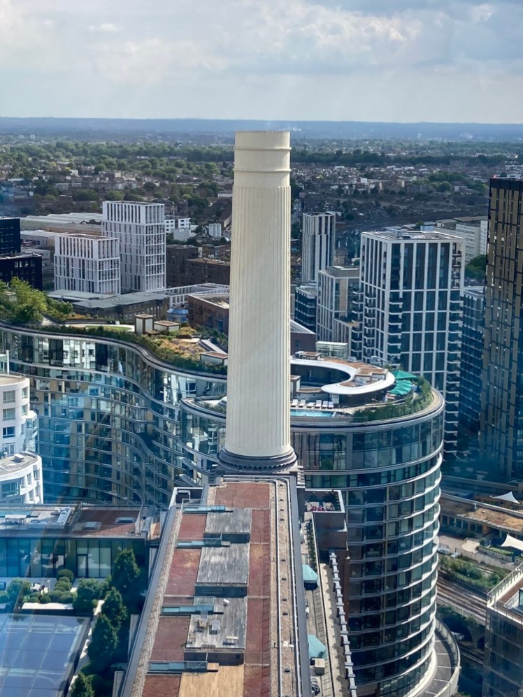Looking across the roof of the power station to the chimney at the other end of the building and behind it, there's a swimming pool on the roof of one of the new buildings; especially appealing when you're in a boiling glass box like we were.