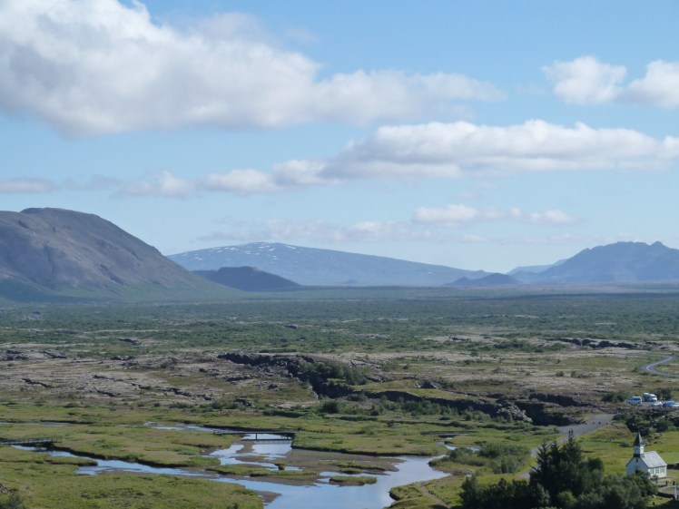 Skjaldbreiður in the distance, a slightly hazy volcano with gentle sides sloping gradually upwards to a point in the middle.