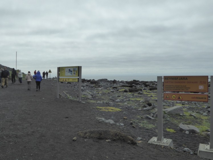 Signs up at Reynisfjara in the summer of 2018 - there's a big orange warning sign explaining that it's dangerous, followed by a yellow one detailing sneaker waves followed by a third warning triangle, and that's just the ones visible in this picture.