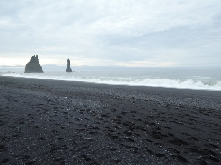 Waves rolling up and crashing onto the black sand at Reynisfjara.