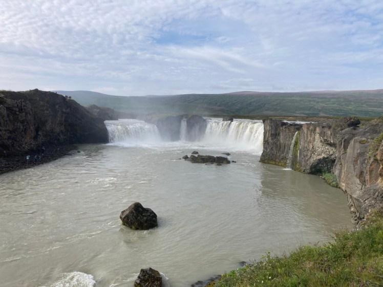 Goðafoss as seen from a viewpoint on the left bank. It's a horseshoe waterfall with enough lumps of solid rock in it to divide the falls into two or three separate parts.