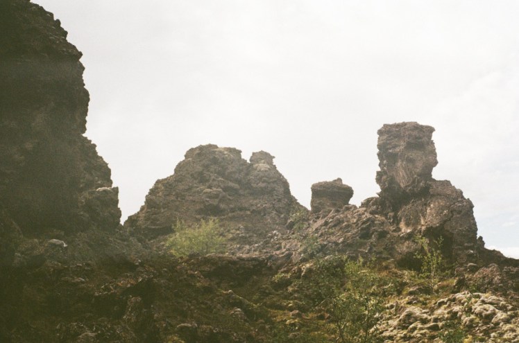 Irregular rocks at Dimmuborgir sticking out of the forest bowl.
