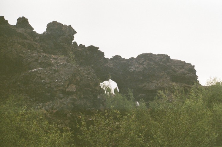A circular "window" or arch in a free-standing bit of lava cliff at Dimmuborgir.