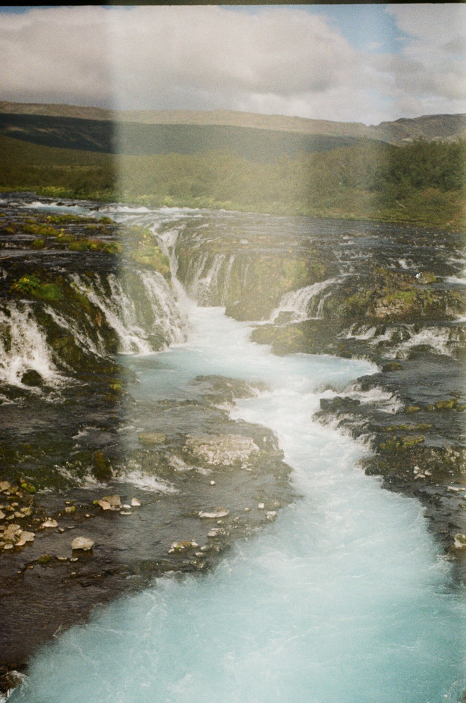 Bruarfoss as seen from the middle of the bridge in front of it, with the light leak again.
