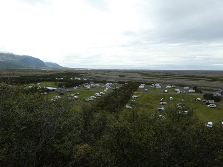 A view over the campsite as you get down the path. It's eight fields divided by hedges and a gravel track and beyond it is the expanse of sandur and a corner of Vatnajökull.