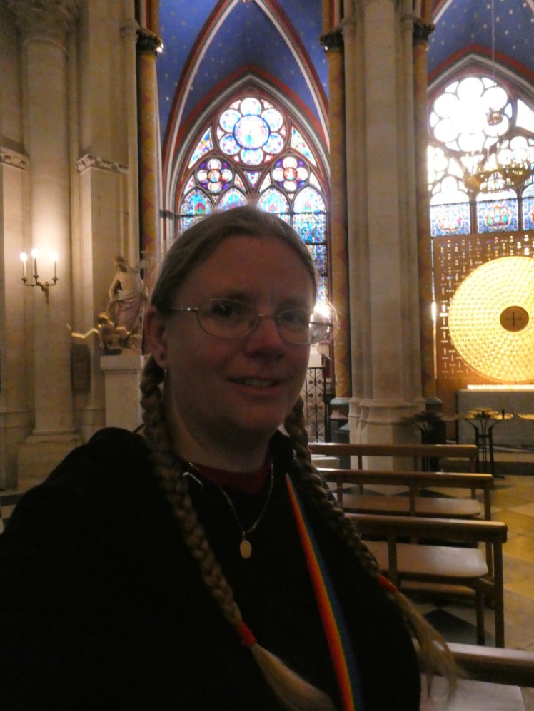 A selfie in the chapel at the east end with lovely stained glass and a big gold disc with the Crown of Thorns in the middle of it.