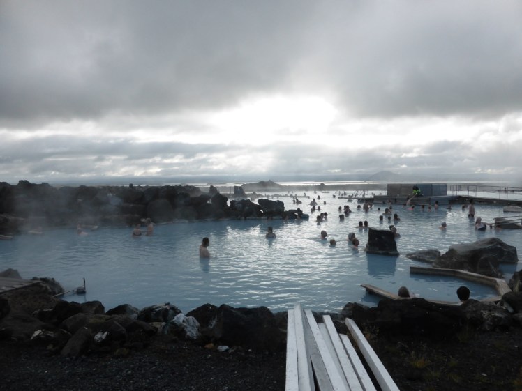 Myvatn Nature Baths, or the Earth Lagoon, seen from the side, with the light of the low afternoon sun shining on its blue waters.