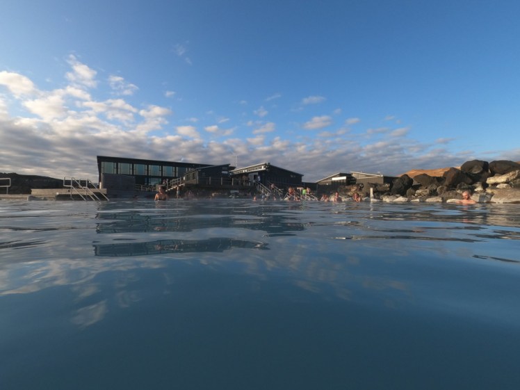 The Earth Lagoon looking towards the current service building with a hint of orange volcano poking over the top and catching the light from the sunset.