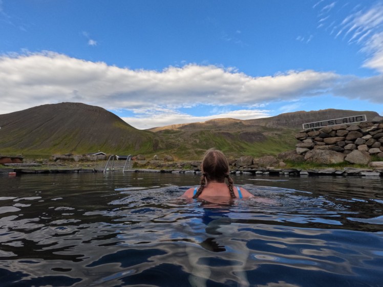 Me in Grettislaug, back to the camera looking at the mountains. It's quite a big pool, ringed by rocks and with a set of pool steps going down into it although everything else has come directly from the shoreline.