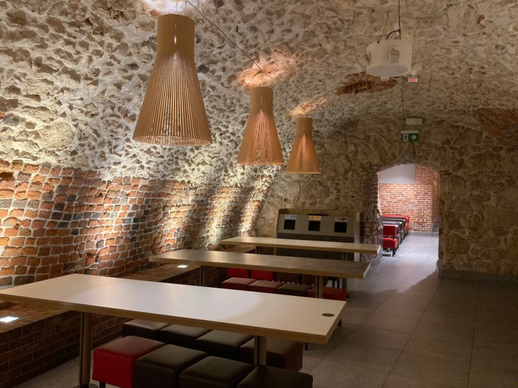A brick and stone medieval cellar now used as extra underground seating for the McDonalds above it.