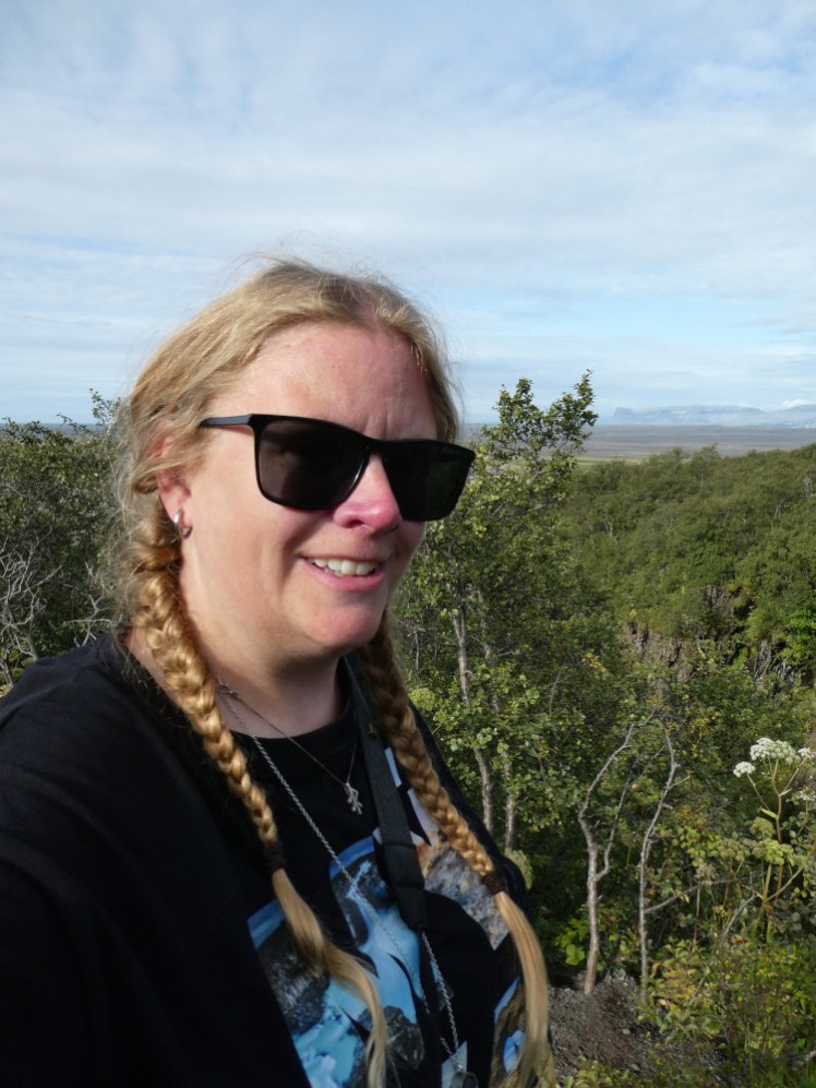 A selfie halfway up the hill, with the view beginning to appear above the trees. I definitely didn't stop for this picture because I didn't have enough breath to keep walking...