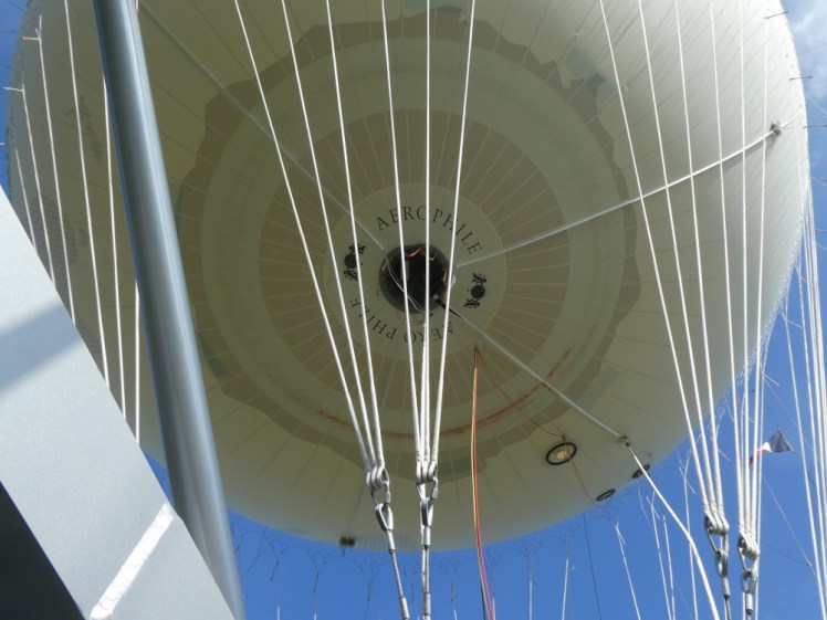 A view to the underneath of the balloon and all its cables and ropes as seen from the gondola.