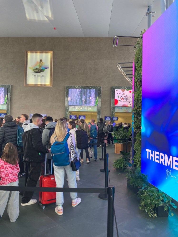 The queue at the entrance of the Therme at just after 10am, going back beyond the barriers.