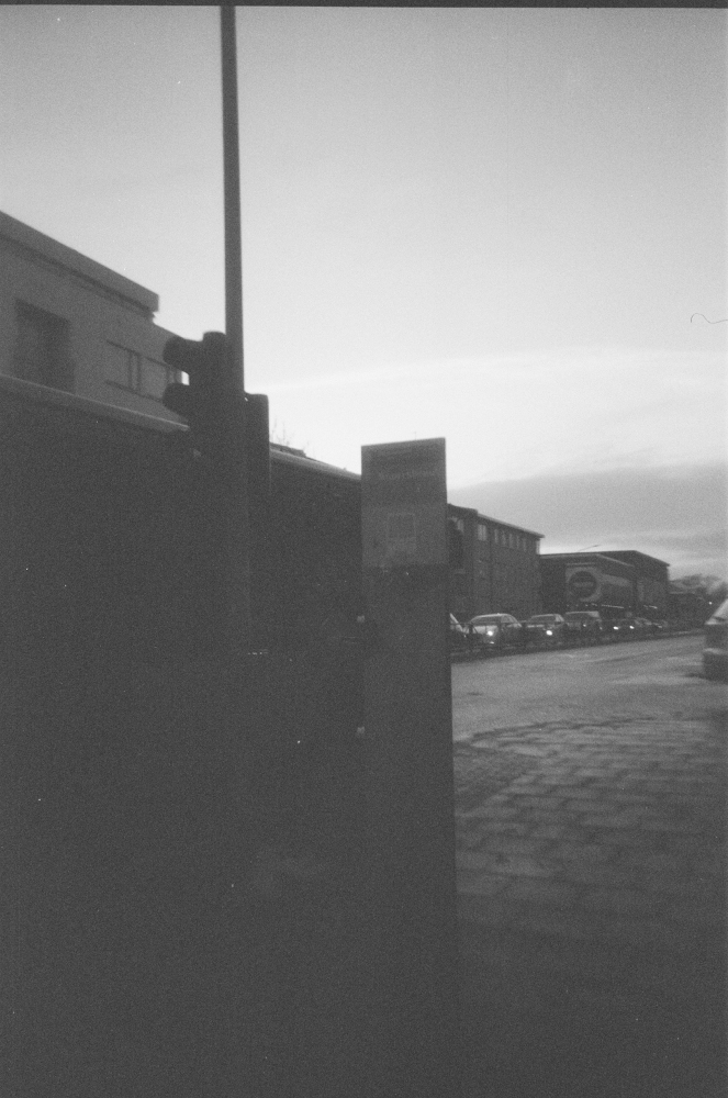 The tourist bus stop on the side of the road at Snorrabraut, with a queue of traffic waiting at the lights on the other side.