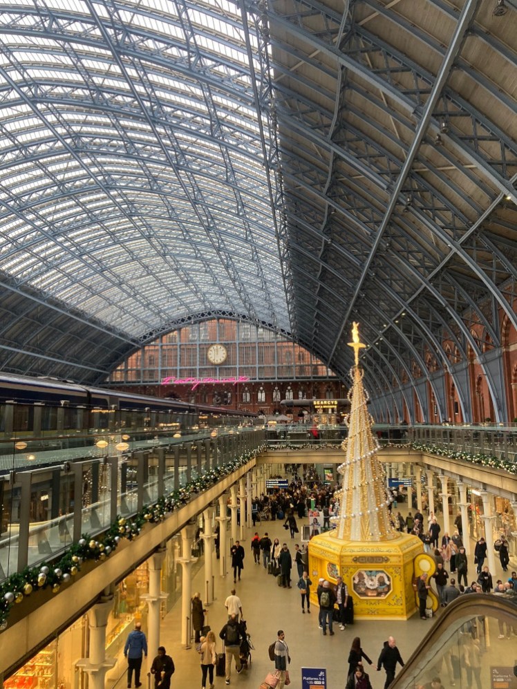 St Pancras station, featuring the famous Christmas tree and the massive curved wrought iron roof.
