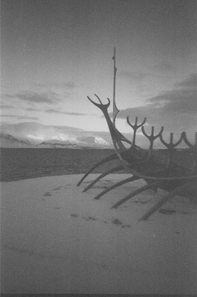 The Sun Voyager, a stainless steel stylised Viking ship, standing proud in front of the bay and the gleaming snows of Esja opposite.